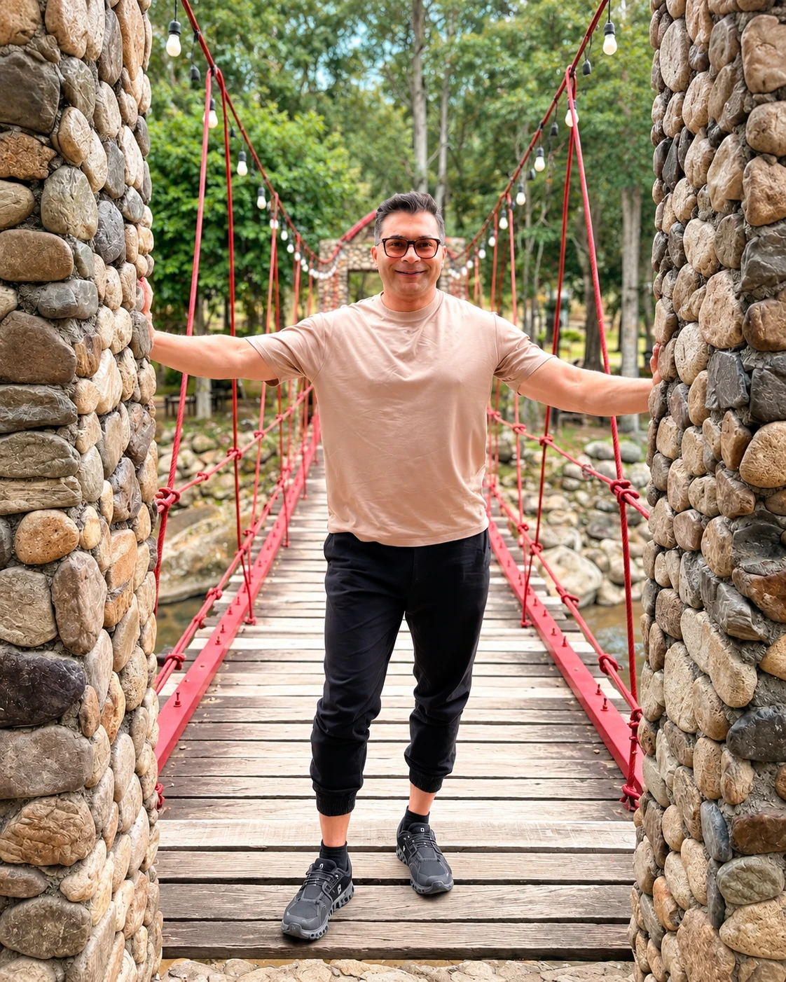 Farhan Ahmad standing on a suspension bridge outdoors.