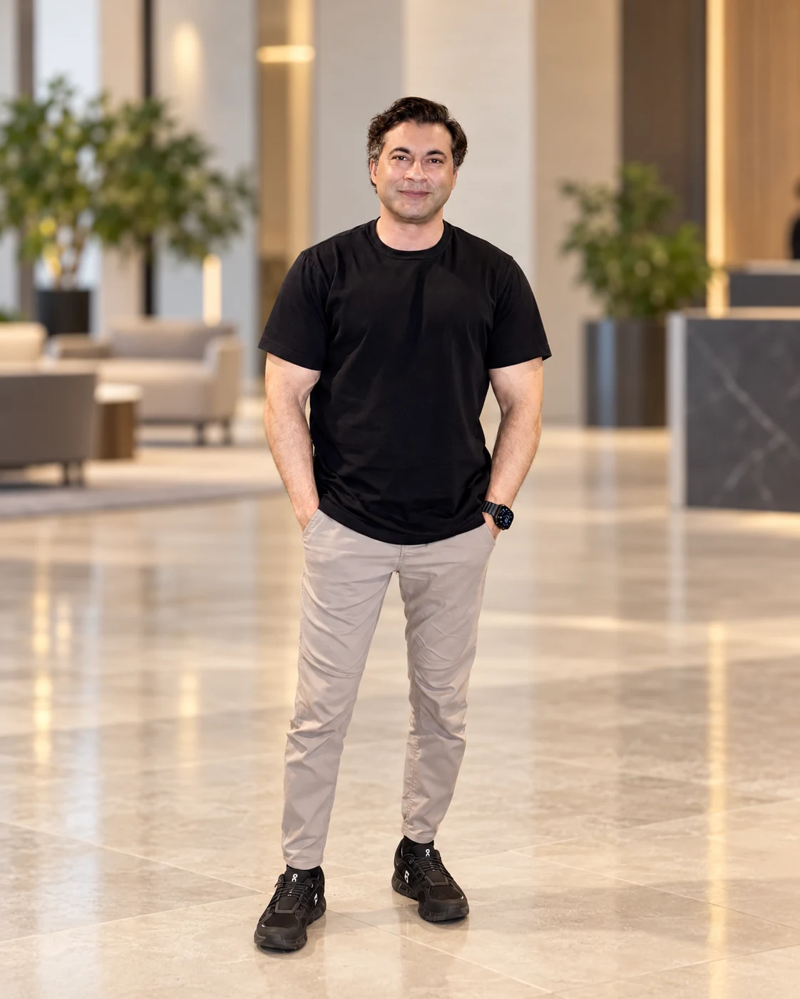 Full-length portrait of Farhan Ahmad in a black T-shirt and light trousers.